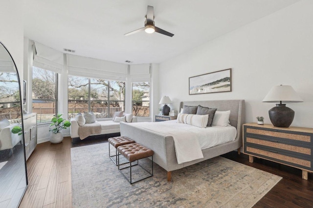 bedroom with visible vents, wood finished floors, and a ceiling fan