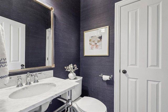bathroom with toilet and a sink