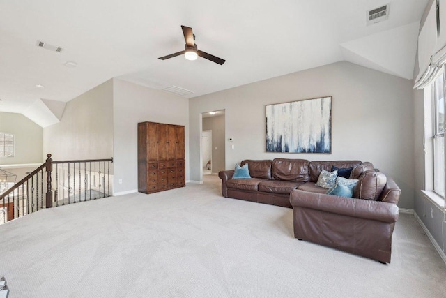 living room with lofted ceiling, a ceiling fan, and visible vents