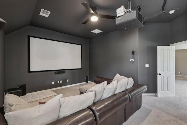 carpeted cinema room with lofted ceiling, a ceiling fan, visible vents, and baseboards