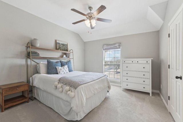 bedroom featuring baseboards, light carpet, a ceiling fan, and vaulted ceiling