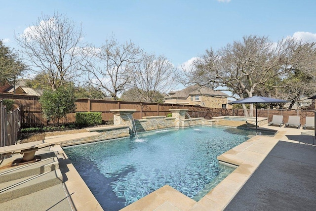 view of swimming pool with a patio, a fenced backyard, and a pool with connected hot tub