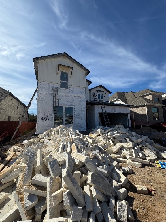 rear view of house featuring fence
