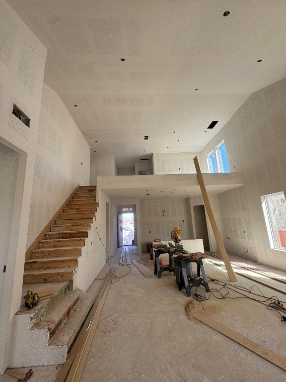 interior space with stairs and a high ceiling