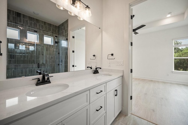 1601 Cardinal Ln, Round Rock, TX 78681 - bathroom with double vanity, a shower stall, and a ceiling fan