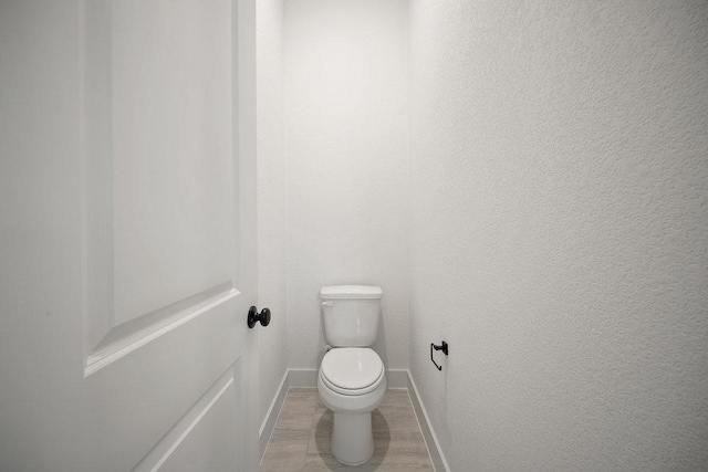 1601 Cardinal Ln, Round Rock, TX 78681 - bathroom featuring baseboards and toilet