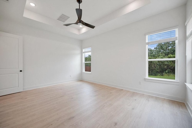 1601 Cardinal Ln, Round Rock, TX 78681 - unfurnished room with a tray ceiling, light wood finished floors, baseboards, a ceiling fan, and recessed lighting
