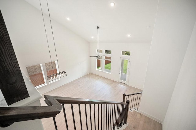 1601 Cardinal Ln, Round Rock, TX 78681 - stairway with wood finished floors, lofted ceiling, recessed lighting, and baseboards
