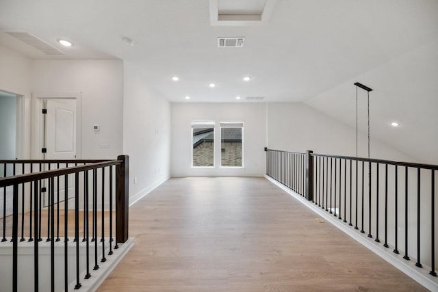 1601 Cardinal Ln, Round Rock, TX 78681 - hall featuring light wood-style flooring, an upstairs landing, lofted ceiling, recessed lighting, and baseboards