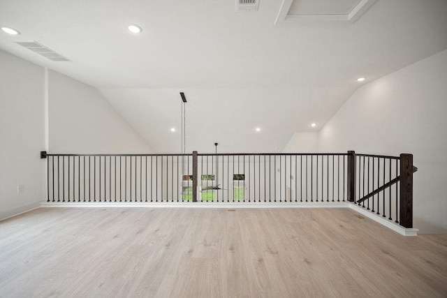 1601 Cardinal Ln, Round Rock, TX 78681 - spare room with wood finished floors, lofted ceiling, and recessed lighting