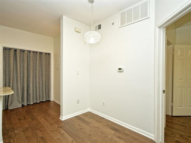 2209 Hancock Dr Unit 4, Austin, TX 78756 - unfurnished dining area featuring dark wood-style floors and baseboards
