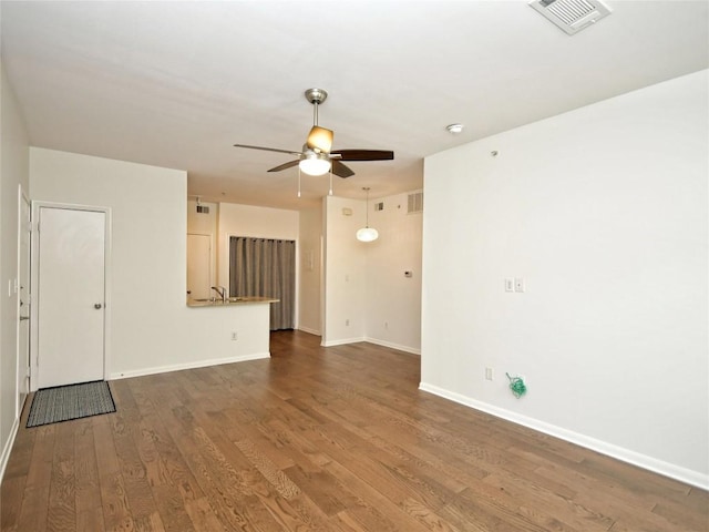 2209 Hancock Dr Unit 4, Austin, TX 78756 - unfurnished living room featuring a ceiling fan, baseboards, and wood finished floors