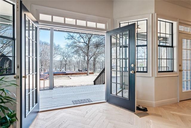 doorway to outside with french doors and baseboards