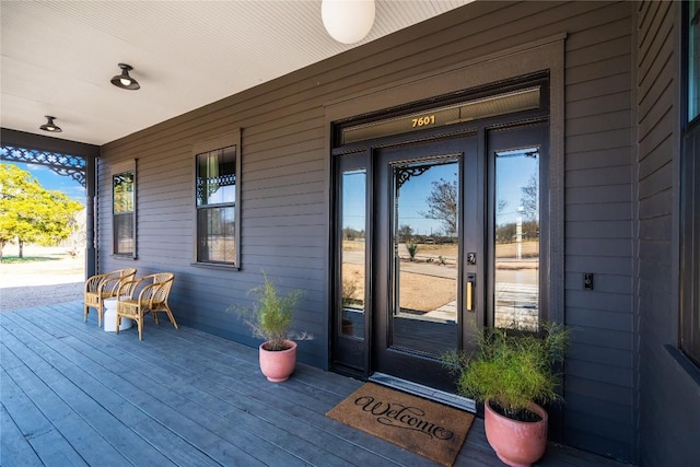 view of exterior entry featuring a porch