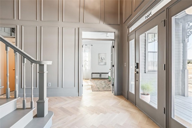 entrance foyer with stairway and a decorative wall