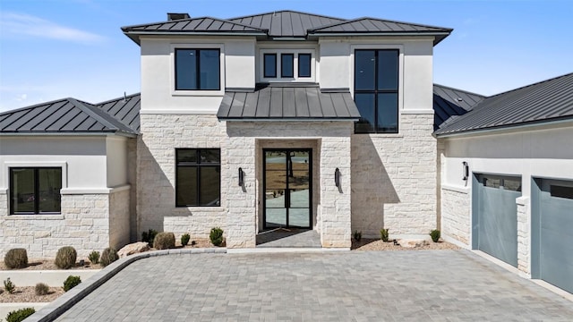 3113 Stableford Cv, Spicewood, TX 78669 - contemporary house with a standing seam roof, a metal roof, and stone siding