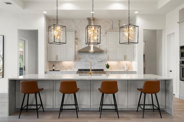 3113 Stableford Cv, Spicewood, TX 78669 - kitchen with decorative backsplash, light wood-style floors, light stone counters, and recessed lighting