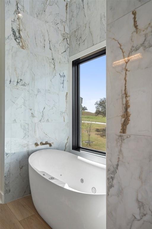 3113 Stableford Cv, Spicewood, TX 78669 - full bathroom with a freestanding tub, plenty of natural light, and wood finished floors
