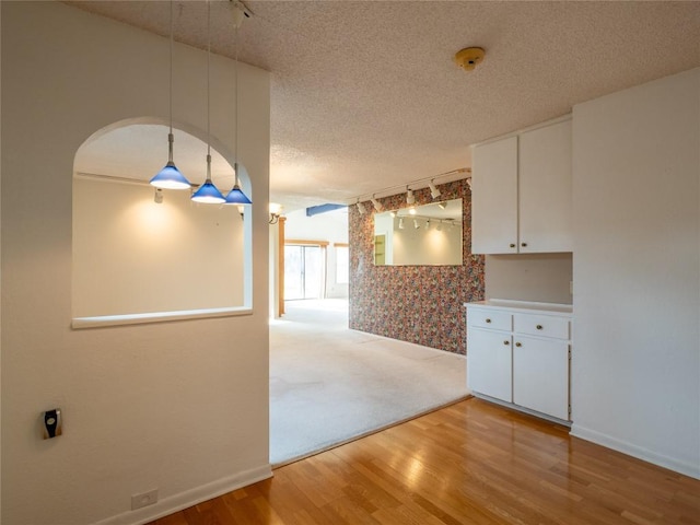 3379 S El Dorado, Lakeway, TX 78734 - empty room featuring light wood-style floors, a smoke detector, rail lighting, and a textured ceiling