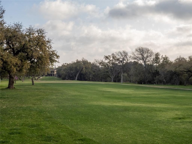 3379 S El Dorado, Lakeway, TX 78734 - view of property's community featuring a lawn and view of wooded area