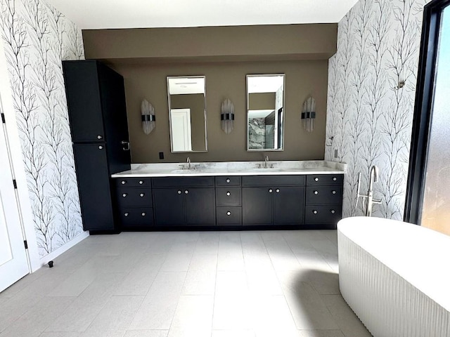705 E 50th St, Austin, TX 78751 - bathroom featuring a sink, a soaking tub, double vanity, and wallpapered walls