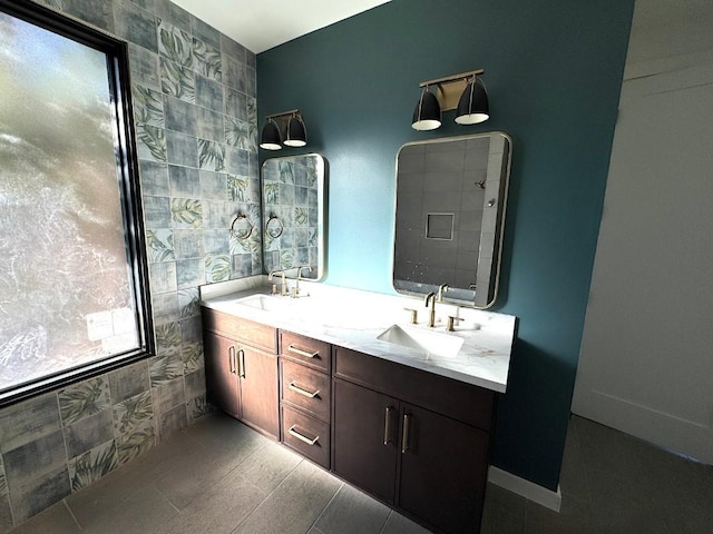 705 E 50th St, Austin, TX 78751 - bathroom featuring double vanity, tiled shower, tile walls, and a sink