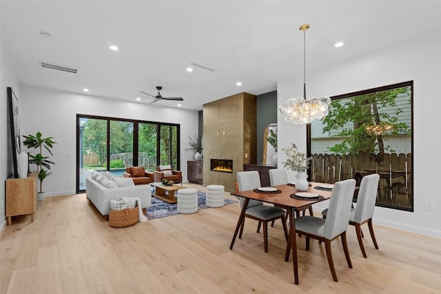 705 E 50th St, Austin, TX 78751 - dining room featuring light wood-style flooring, recessed lighting, a fireplace, ceiling fan, and a chandelier