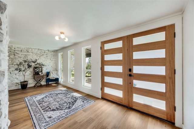 11704 Indianhead Dr, Austin, TX 78753 - foyer with light wood-type flooring, ornamental molding, and a chandelier
