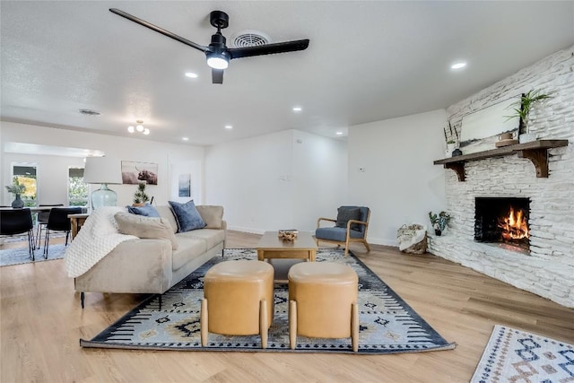 11704 Indianhead Dr, Austin, TX 78753 - living area with a ceiling fan, a fireplace, wood finished floors, and recessed lighting