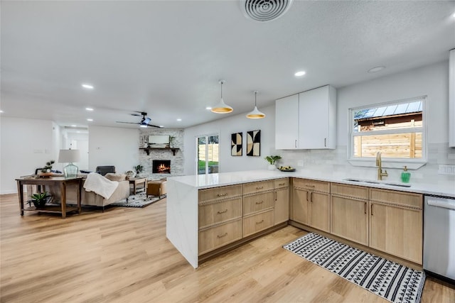 11704 Indianhead Dr, Austin, TX 78753 - kitchen with dishwasher, light brown cabinetry, light countertops, decorative backsplash, and light wood-style flooring