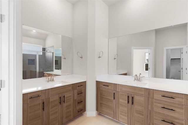 2705 Sage Ranch Dr Unit 26, Leander, TX 78641 - bathroom with a shower stall, two vanities, tile patterned flooring, and a high ceiling