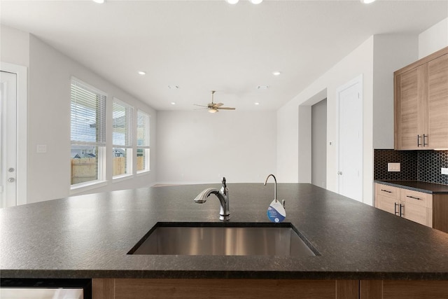 2705 Sage Ranch Dr Unit 26, Leander, TX 78641 - kitchen featuring a sink, ceiling fan, recessed lighting, tasteful backsplash, and a center island with sink