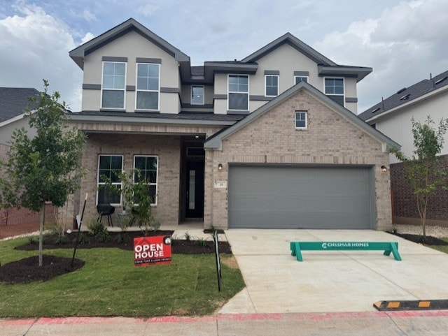 2705 Sage Ranch Dr Unit 26, Leander, TX 78641 - traditional-style house featuring driveway, brick siding, stucco siding, and a front lawn