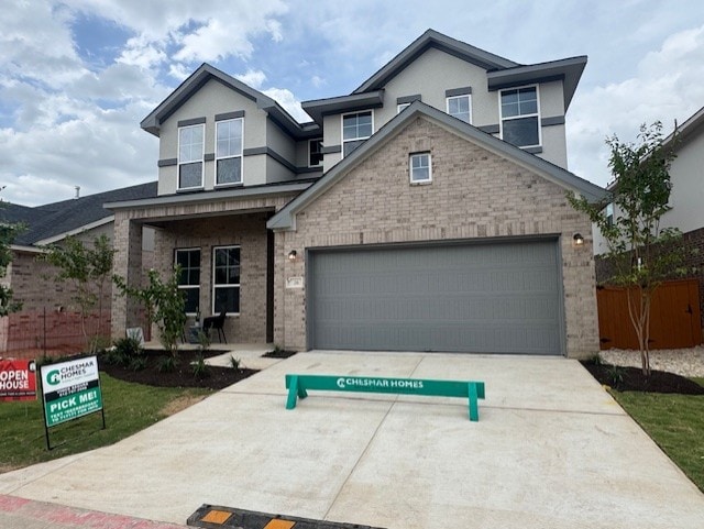 2705 Sage Ranch Dr Unit 26, Leander, TX 78641 - view of front of home with brick siding, driveway, stucco siding, and a garage