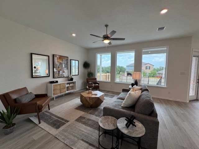 2705 Sage Ranch Dr Unit 26, Leander, TX 78641 - living room with wood finished floors, a ceiling fan, and recessed lighting