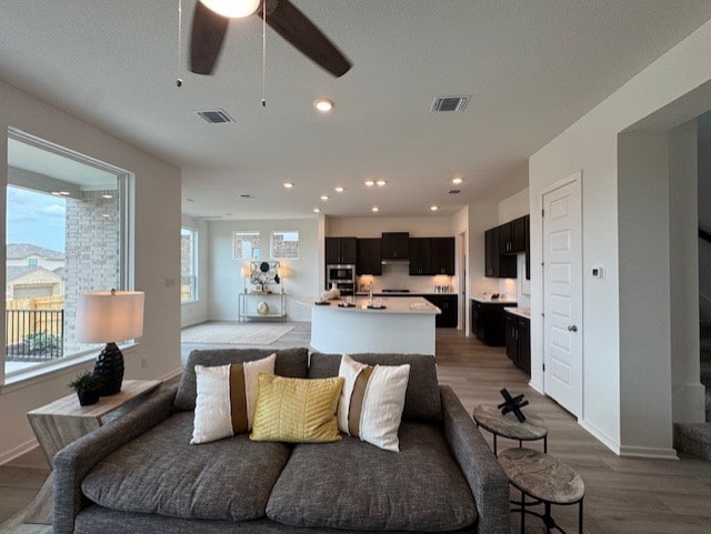 2705 Sage Ranch Dr Unit 26, Leander, TX 78641 - living room with light wood-style floors, a ceiling fan, and recessed lighting