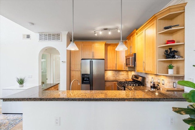 kitchen featuring open shelves, arched walkways, visible vents, and stainless steel appliances