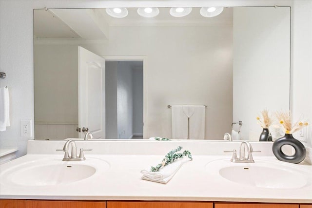 bathroom featuring double vanity, a sink, and ornamental molding