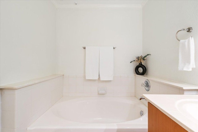 full bath featuring a bath, crown molding, and vanity