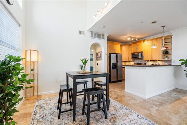 kitchen with dark countertops, appliances with stainless steel finishes, open shelves, and visible vents