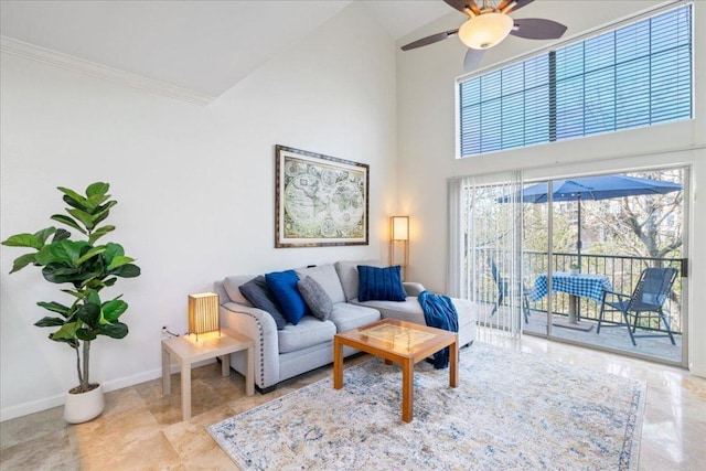 living room with a ceiling fan, baseboards, high vaulted ceiling, and ornamental molding