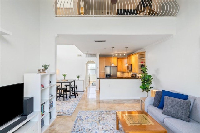 living area featuring visible vents and arched walkways