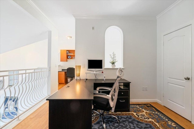 home office with baseboards, crown molding, and light wood-style floors