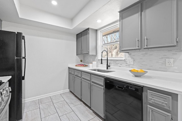 1002 Parkside Cir, Round Rock, TX 78664 - kitchen featuring black appliances, gray cabinets, backsplash, light countertops, and recessed lighting