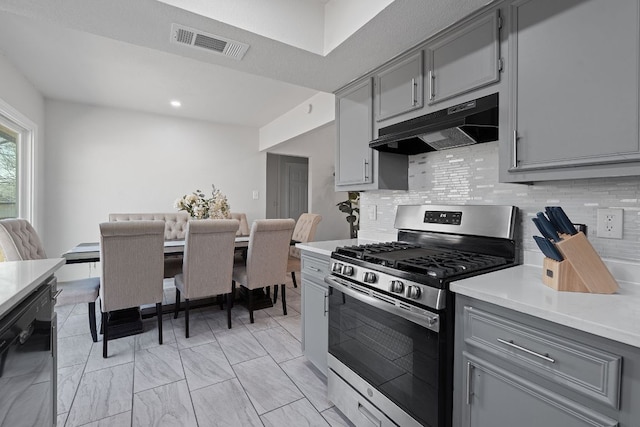 1002 Parkside Cir, Round Rock, TX 78664 - kitchen with stainless steel gas range, under cabinet range hood, gray cabinets, black dishwasher, and light countertops