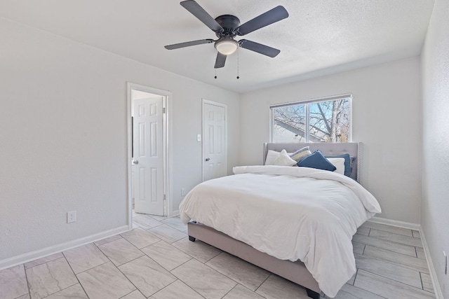 1002 Parkside Cir, Round Rock, TX 78664 - bedroom featuring baseboards and a ceiling fan