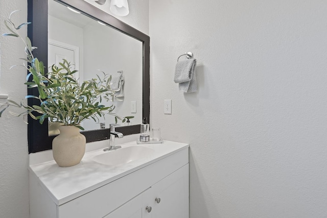 1002 Parkside Cir, Round Rock, TX 78664 - bathroom with vanity and a textured wall