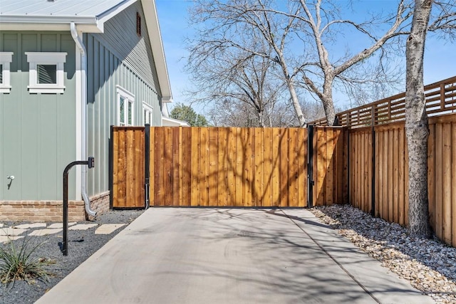 703 E 15th St, Georgetown, TX 78626 - view of side of property with board and batten siding and a gate