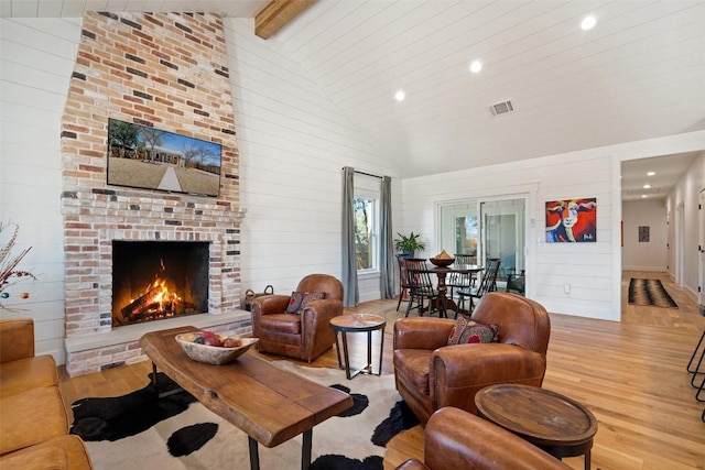 703 E 15th St, Georgetown, TX 78626 - living room featuring light wood-style flooring, recessed lighting, high vaulted ceiling, beamed ceiling, and a fireplace