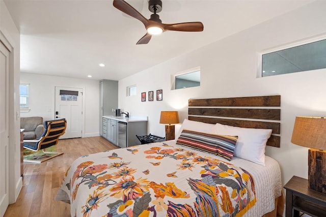 703 E 15th St, Georgetown, TX 78626 - bedroom with light wood finished floors, recessed lighting, stainless steel refrigerator, and a ceiling fan